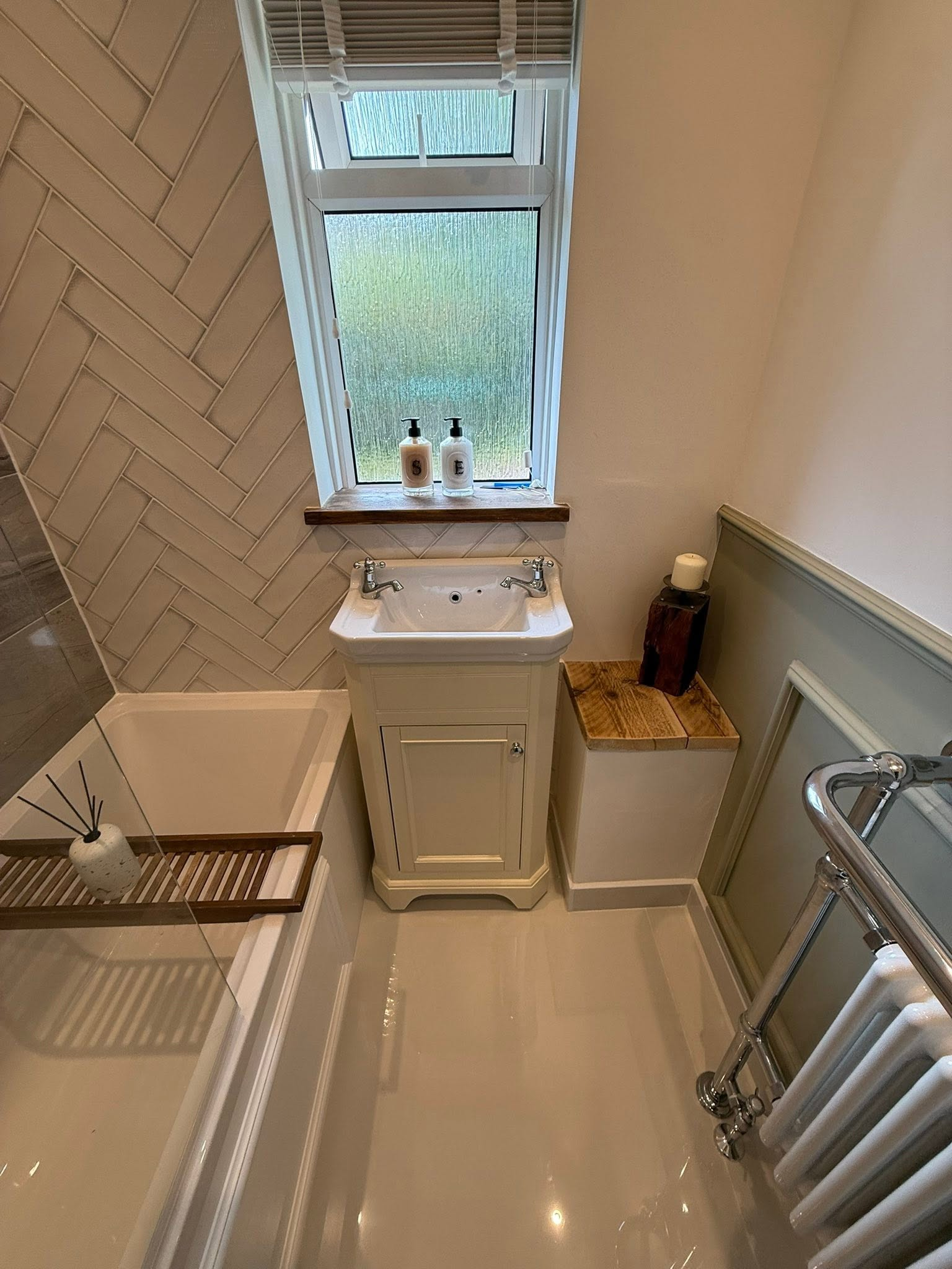 Finished bathroom with vanity unit and feature tiling