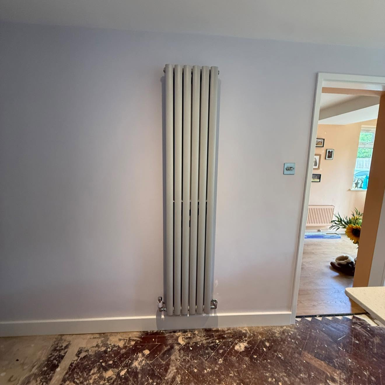 White vertical designer radiator installation